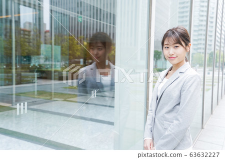 Young business woman walking in office city Young business woman walking in office city 63632227