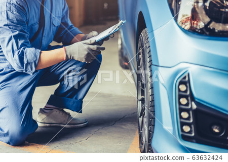 Asian car mechanic technician holding clipboard 63632424