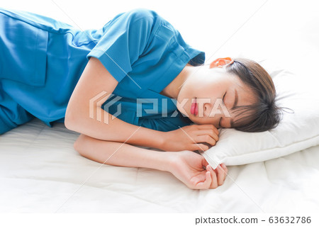Young nurse taking a nap Young nurse taking a nap 63632786