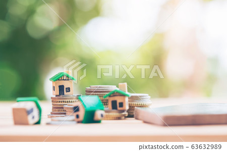 Mini house model and stack of coins. Business risk Mini house model and stack of coins. Business risk 63632989