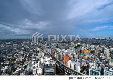 Tokyo cityscape in Japan City center blurred by heavy rain and big rainbow 63635047