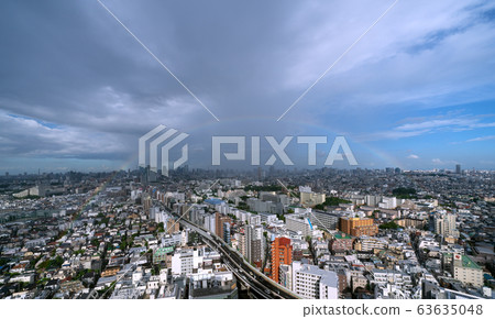 Tokyo cityscape in Japan City center blurred by heavy rain and big rainbow 63635048