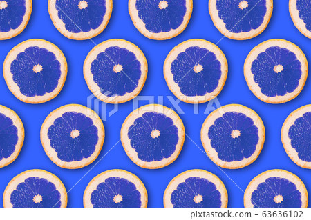 summer pattern with juicy ripe fresh slices of orange blue on a blue background summer pattern with juicy ripe fresh slices of orange blue on a blue background 63636102