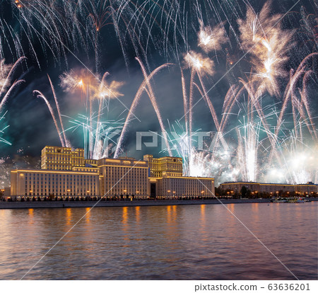 Main Building of the Ministry of Defence of the Russian Federation-- is the governing body of the Russian Armed Forces and celebratory colorful fireworks exploding in the skies. Moscow, Russia 63636201