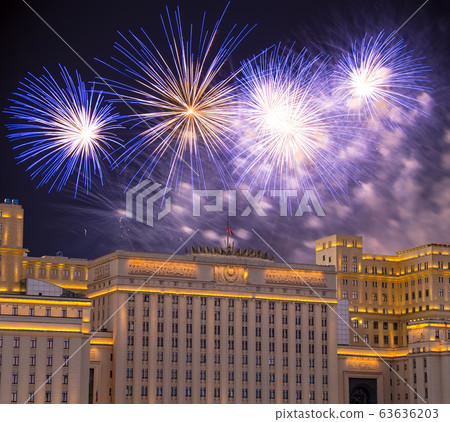 Main Building of the Ministry of Defence of the Russian Federation-- is the governing body of the Russian Armed Forces and celebratory colorful fireworks exploding in the skies. Moscow, Russia 63636203