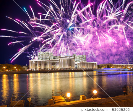 Main Building of the Ministry of Defence of the Russian Federation-- is the governing body of the Russian Armed Forces and celebratory colorful fireworks exploding in the skies. Moscow, Russia 63636205