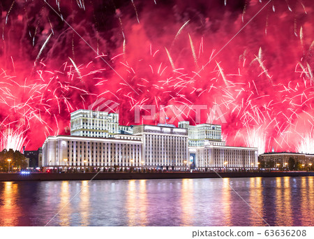 Main Building of the Ministry of Defence of the Russian Federation-- is the governing body of the Russian Armed Forces and celebratory colorful fireworks exploding in the skies. Moscow, Russia 63636208