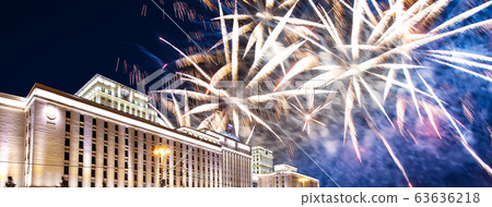 Main Building of the Ministry of Defence of the Russian Federation-- is the governing body of the Russian Armed Forces and celebratory colorful fireworks exploding in the skies. Moscow, Russia 63636218