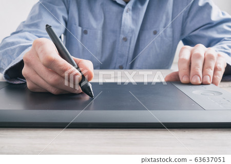 Man using graphical tablet Man using graphical tablet 63637051