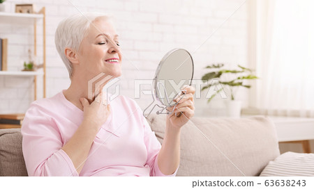 Senior lady looking at mirror, sitting on quarantine at home 63638243