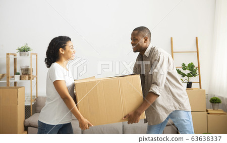 Couple carry out big box of home, make room for repairs Couple carry out big box of home, make room for repairs 63638337