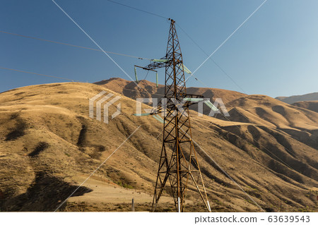 electricity pylon in the mountains. 63639543