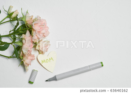 roses on a white background and a card with a congratulation to mother's day.  63640162
