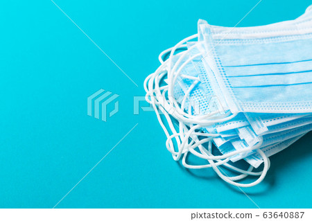 Top view of protective medical masks on blue 63640887