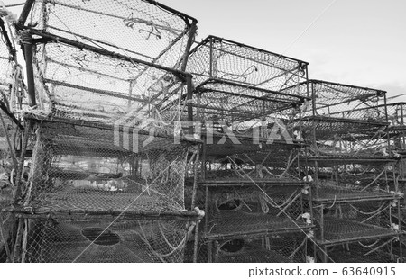 Box shaped crab traps stacked in fishing port Box shaped crab traps stacked in fishing port 63640915