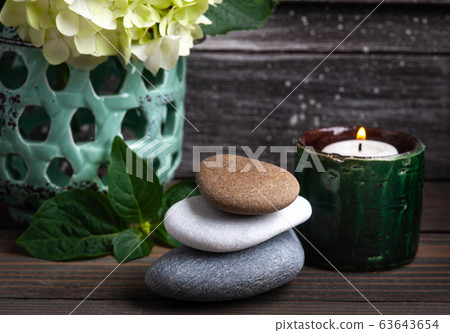 Green aroma candle in Spa still life Green aroma candle in Spa still life 63643654