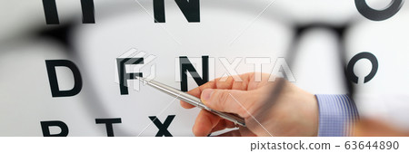 Silver pen pointing to letter in check table through eyeglasses 63644890