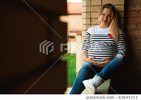 Young preganant woman expecting a baby relaxing Young preganant woman expecting a baby relaxing 63645153
