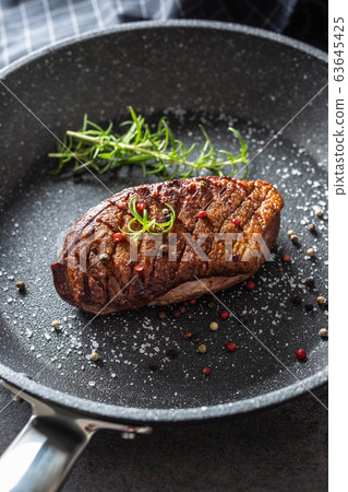 Duck breast roasted in ceramic pan with salt 63645425