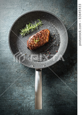 Duck breast roasted in ceramic pan with salt 63645433