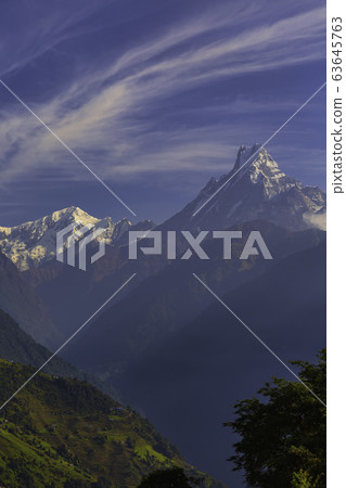 Mount Machhapuchhre or Fishtail in the Himalayas in Nepal. We can see the peak of Machhapuchhre along the way between the walking path to the Annapurna Base Camp. Mount Machhapuchhre or Fishtail in the Himalayas in Nepal. We can see the peak of Machhapuchhre along the way between the walking path to the Annapurna Base Camp. 63645763