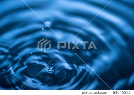 water drop splash in a glass blue colored 63645892