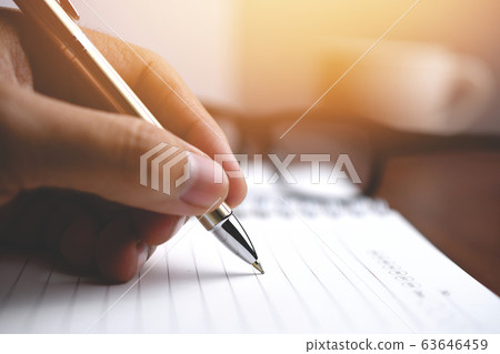 Pen writing on a notebook, Close-up men hand 63646459