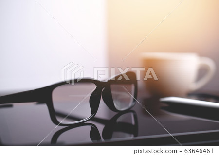 Office workplace, eyeglasses and tablet on Office workplace, eyeglasses and tablet on 63646461