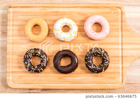 Donuts and coffee on wooden table. Donuts and coffee on wooden table. 63646675