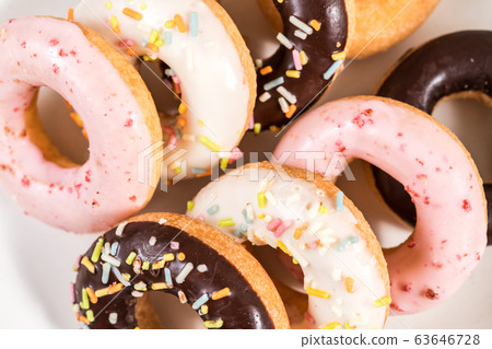 Donuts and coffee on wooden table. Donuts and coffee on wooden table. 63646728