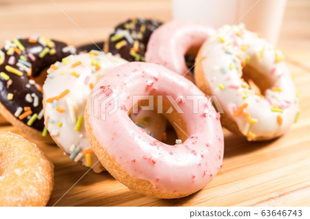 Donuts and coffee on wooden table. Donuts and coffee on wooden table. 63646743