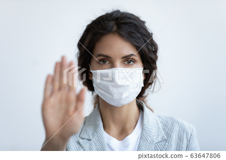 Woman in medical mask show stop gesture to stop pandemic Woman in medical mask show stop gesture to stop pandemic 63647806
