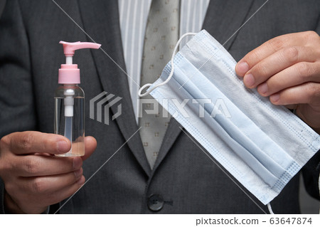 a man demonstrates a protective face mask for 63647874