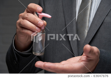 a man demonstrates a protective face mask for 63647876