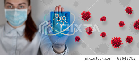 Stop coronavirus. Young doctor in a medical mask shows stop viruses or cancer on a gray background. Attack of red infected cells. Immunity protective shield against bacteria 63648792