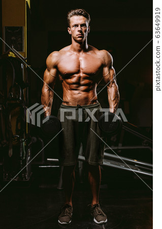 Handsome Fit Man Tightening His Muscles 63649919