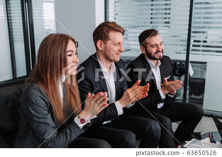 group of business people clapping hands to congratulate their boss - Business company team group of business people clapping hands to congratulate their boss - Business company team 63650526
