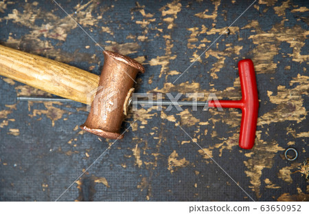hammer and screwdriver on desk at repair shops hammer and screwdriver on desk at repair shops 63650952