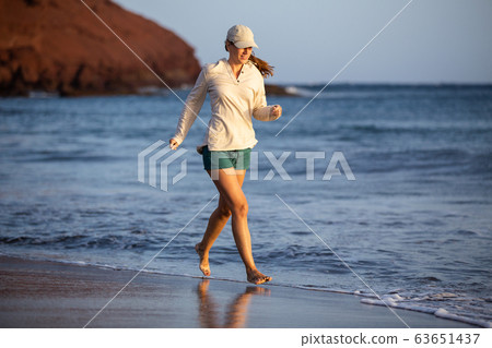 Young woman having fun at ocean beach on vacation 63651437