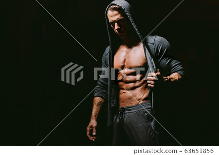 Brutal man wearing hoodie on naked body. 63651856