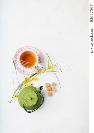 Cup of herbal tea. Mimosa branch decoration. Cup of herbal tea. Mimosa branch decoration. 63652567