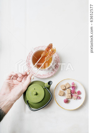 Cup of herbal tea. Hand serving. Cup of herbal tea. Hand serving. 63652577