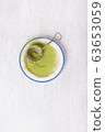 Vintage metal strainer with Matcha tea on ceramic 63653059
