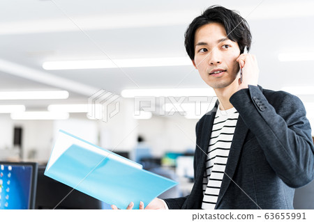 Young businessman (office, smartphone, file, office casual Young businessman (office, smartphone, file, office casual 63655991