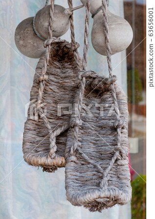 The village of Shirakawa, a world heritage site, with its traditional houses with gassho-zukuri-style roofs and traditional straw sandals 63656001