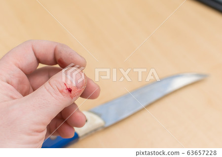 The hand that holds a sharp knife 63657228