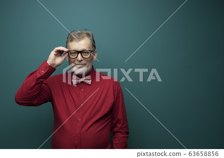 Portrait of a positive elderly man in glasses Portrait of a positive elderly man in glasses 63658856