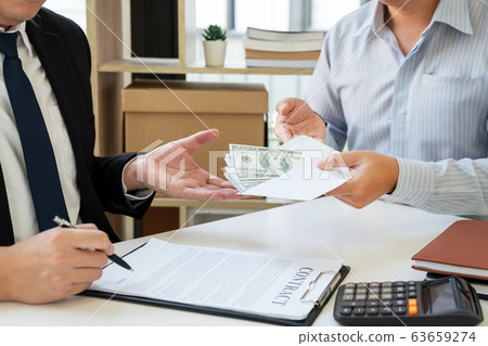 Businessman giving bribe money dollar banknotes in Businessman giving bribe money dollar banknotes in 63659274