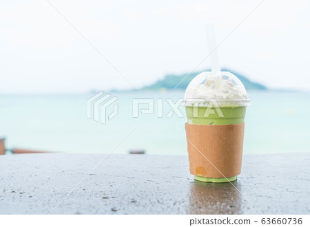 iced greentea cup with sea background iced greentea cup with sea background 63660736