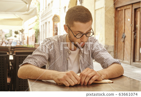 young man about to read a book 63661074